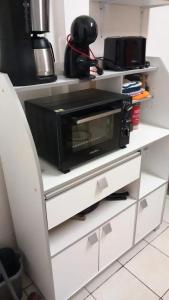 a microwave oven sitting on a shelf in a kitchen at Maison adorable à Sainte-Luce avec jardin clos in Sainte-Luce