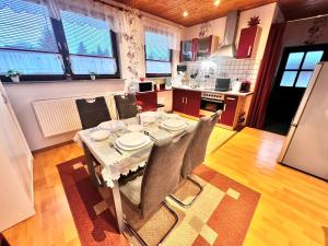 a kitchen with a table and chairs in a room at Ferienwohnung Ausblick in Samtens