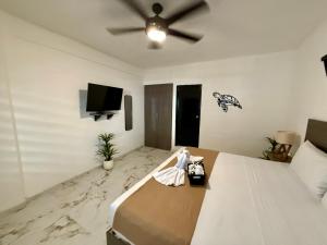 a bedroom with a bed and a ceiling fan at CASA TORTUGA 5Th Ave in Playa del Carmen +64 photos