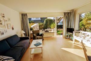 a living room with a couch and a table at Haus Hanne Sylt Wohnung Erdgeschoss in Sylt