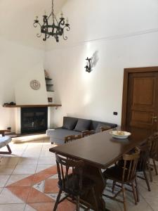 a living room with a table and a couch at La Petra in Vico Equense +47 photos