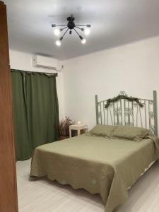 a bedroom with a bed and a ceiling fan at La Perla in Nueva Helvecia