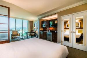 a hotel room with a large bed and a balcony at MGM Studio View of Top Golf MGM Wet Republic 22604 in Las Vegas +19 photos