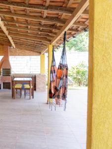 a patio with two umbrellas and a table and chairs at Casa com WiFi em Morro do Moreno, Angra dos Reis in Angra dos Reis