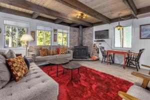 a living room with a couch and a fireplace at Glacier Peak Getaway | Wifi, Fireplace, Lower Timb in Packwood
