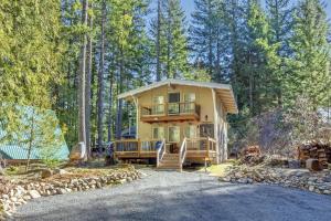 a large house with a deck in the woods at Glacier Peak Getaway | Wifi, Fireplace, Lower Timb in Packwood