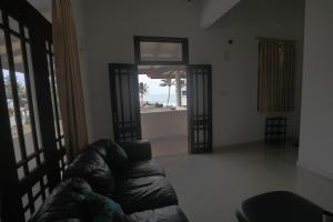 salon z kanapą i widokiem na ocean w obiekcie Mirissa Ocean Breeze Hotel Triple room w mieście Mirissa