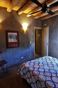 a bedroom with a bed in a room with a ceiling at Casa H entre viñedos in Ciudad Lujan de Cuyo +6 photos