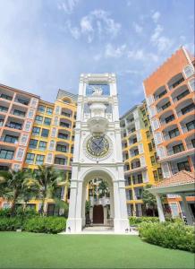 a clock tower in front of a building at Eleanor Homes in Jomtien Beach