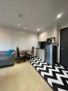 a kitchen with a couch and a table in a room at Eleanor Homes in Jomtien Beach