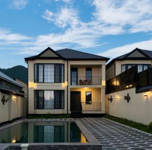 a large house with a pool in front of it at Gabala Double Villas in Gabala