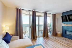 a living room with a view of the ocean at Sandy Daydreams, Unit PH3 in Myrtle Beach