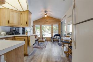 a kitchen with a refrigerator and a living room at Minimalist Hideaway | WiFi, BBQ, Smart TV, Close t in Packwood