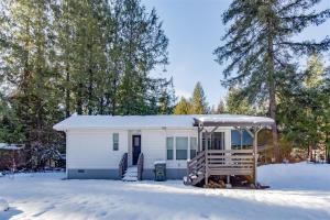 a white tiny house with a gazebo in the snow at Minimalist Hideaway | WiFi, BBQ, Smart TV, Close t in Packwood