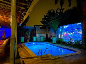 ein Schwimmbad bei Nacht mit einem Bildschirm in der Unterkunft Villa Kalm in Abidjan