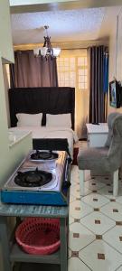 a kitchen with a stove in the middle of a room at Waiyaki Way homes in Rungiri