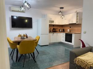 a kitchen and dining room with a table and chairs at Tsvetanov Apartment in Blagoevgrad