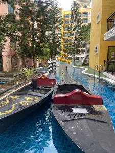 two can boats in a pool in a city at Eleanor Homes in Jomtien Beach