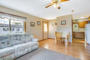 a living room with a couch and a table at Michigan Manistee River Cabin about 1 Mi to Downtown in Manistee