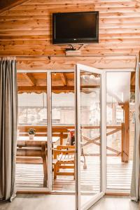 a living room with a flat screen tv on a wooden wall at Oaza Spokoju 1 in Wersk