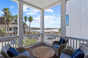 a porch with chairs and a table with a view of the beach at Grayt Digs by AvantStay Next to Beach Oceanview in Santa Rosa Beach