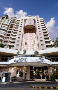a large white building with a store in front of it at Gefinor Rotana – Beirut in Beirut