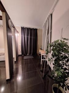 a living room with a table and a chair and a table at Smarthome Suites Centro Storico Collegno in Collegno