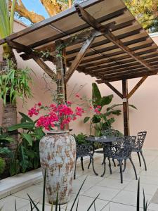 a patio with a table and chairs and flowers at Casa Garay Hotel 658 in Asuncion