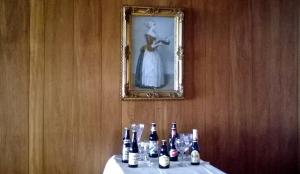 a table with bottles and glasses and a picture on the wall at The Albert Hotel Near Winter Gardens in Blackpool