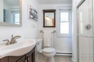a bathroom with a toilet and a sink and a mirror at The Goat Locker in Annapolis +42 photos