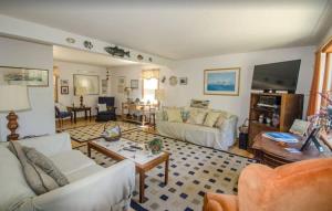 a living room with a couch and a table at Centrally Located Capacious 3 Bedroom in Truro