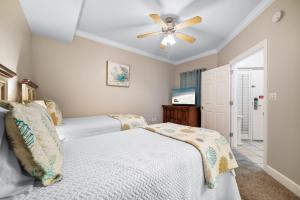 a bedroom with two beds and a ceiling fan at Phoenix on the Bay 1514 in Orange Beach +61 photos