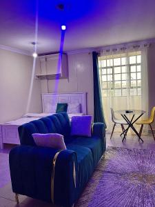 a living room with a couch and a table at Bella Homes Thika Town Studio in Thika