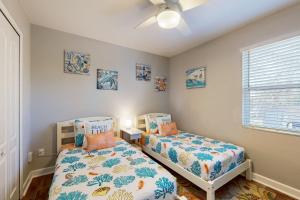 una camera da letto con due letti e un ventilatore a soffitto di Dog-Friendly Family-Focused Peaceful & Private Retreat a St. Augustine