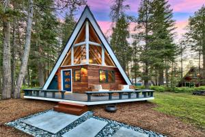 a cabin in the woods with a triangular roof at Elati Escape in South Lake Tahoe