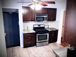 a kitchen with a stove and a microwave at The Price is RIGHT Detroit Home in Detroit +21 photos
