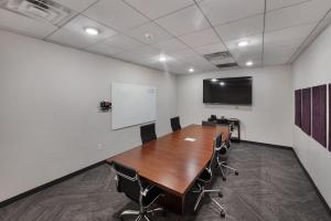 a conference room with a table and a white wall at Expansive views - 1BD 1BA Hot Tub, Pool, Convention Centre in Salt Lake City