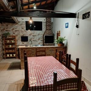 a kitchen with a table and a counter with a sink at Palmenhaus in Pomerode +42 photos
