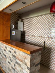 a kitchen with a brick counter top and a refrigerator at Condominio Entre Ríos in Valdivia