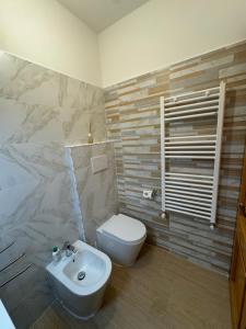 a bathroom with a white toilet and a sink at Attico - Terrazza su Castello in Castel di Sangro +22 photos