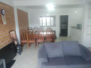 ペーニャにあるCasa na Praia Pertinho do marのソファとテーブルと椅子のあるリビングルーム