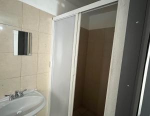 a bathroom with a shower and a sink at 9 VENATOR House Boutique in Miravalle