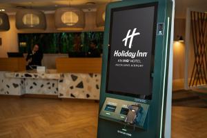 a ticket machine in a room with a lobby at Holiday Inn Auckland Airport by IHG in Auckland