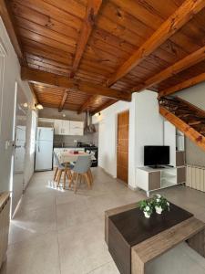 a living room with a table and a kitchen at Rincón del Angel in San Carlos de Bariloche