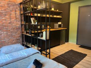 a room with a brick wall and a book shelf at Mickitos Cozy Studio Two in Mavrovo