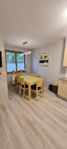 a dining room with a wooden table and chairs at Apartamenty Karpacz in Karpacz