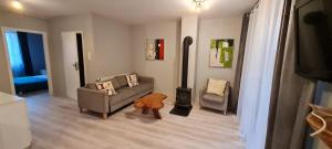 a living room with a couch and two chairs at Apartamenty Karpacz in Karpacz