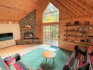 a living room with a couch and a fireplace at Mossy Moose Cabin | Near White Pass & Mt Rainier in Packwood