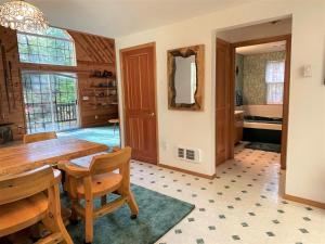a dining room with a wooden table and chairs at Mossy Moose Cabin | Near White Pass & Mt Rainier in Packwood +8 photos