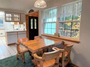 a dining room with a wooden table and chairs at Mossy Moose Cabin | Near White Pass & Mt Rainier in Packwood